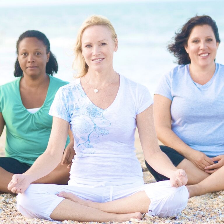 Elizabeth Cantey meditating on the beach with friends