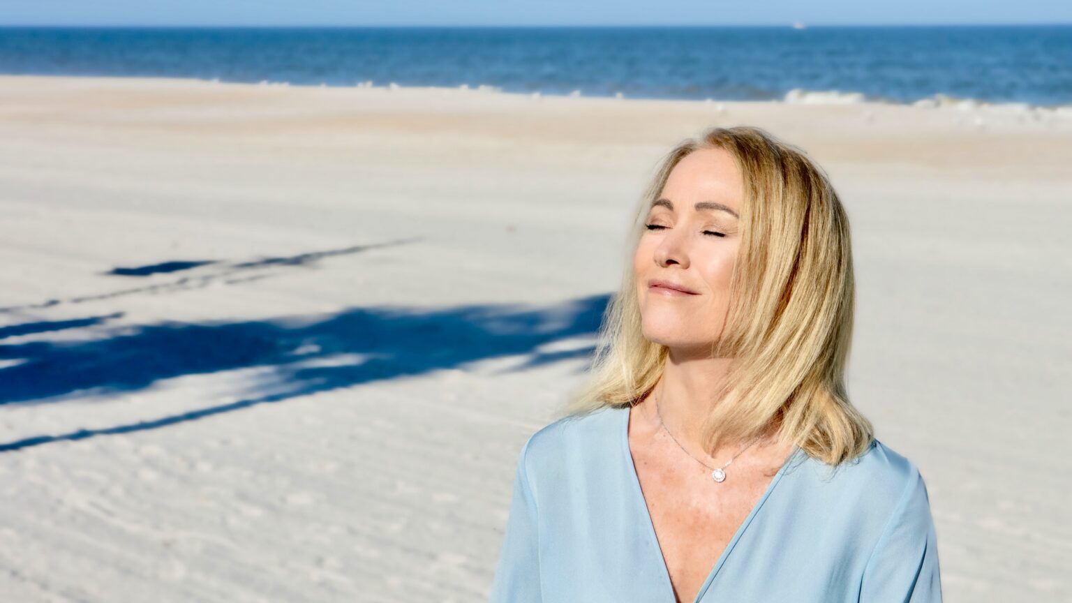 Elizabeth Cantey on the beach, eyes closed